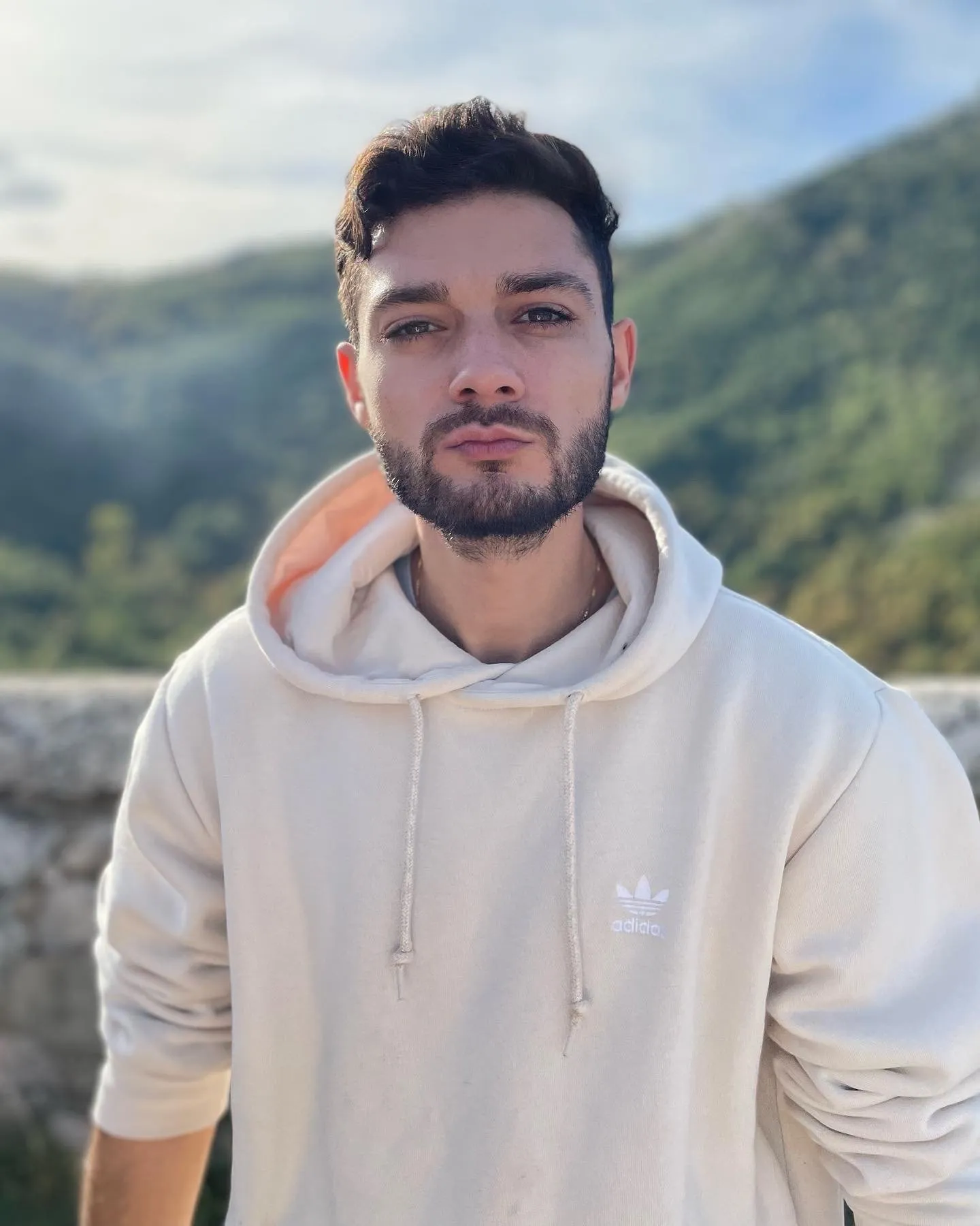Mikey, green mountains behind him.