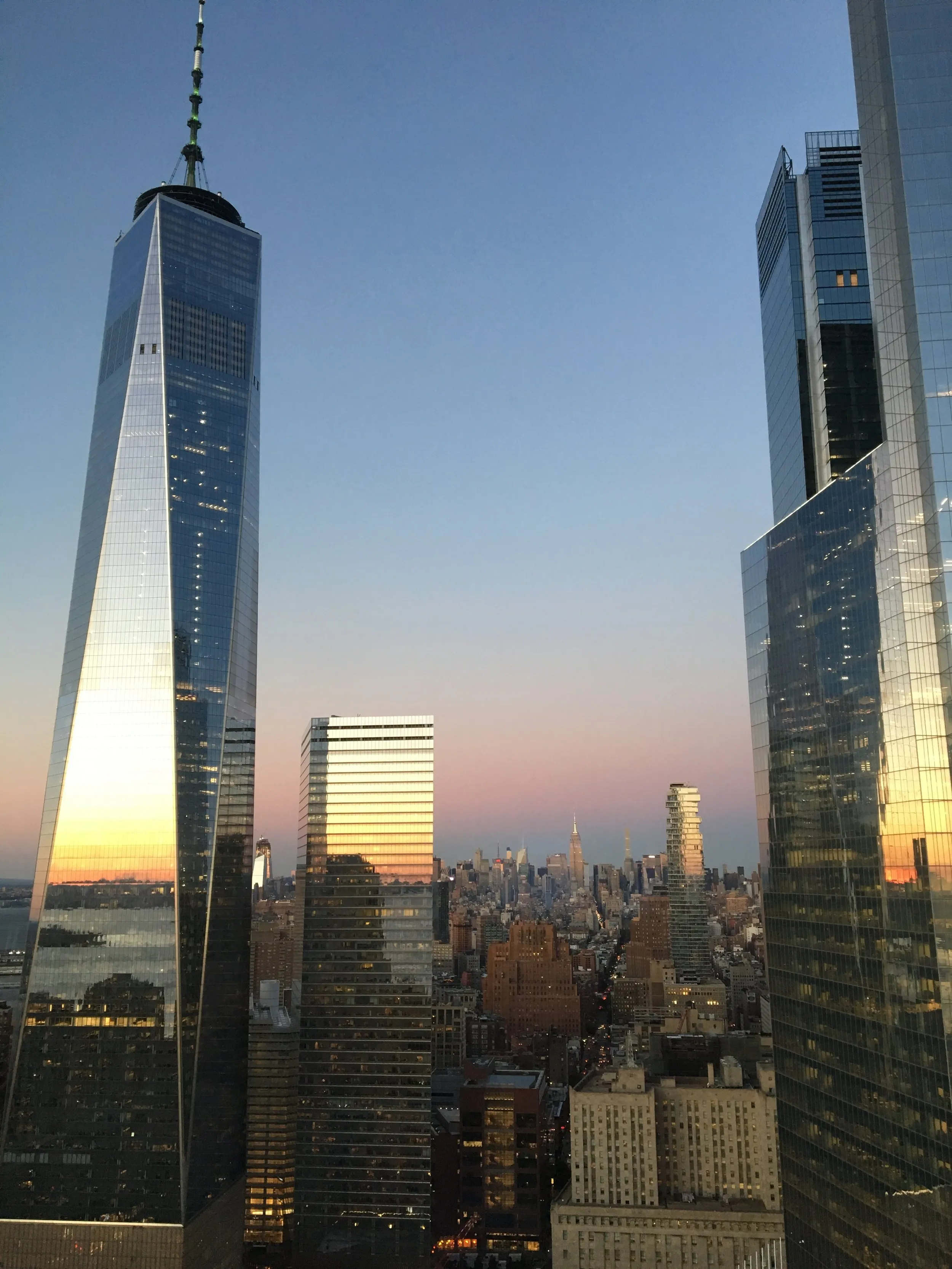 Sunset over the skyline, One World Trade on the left, the Empire State far off.