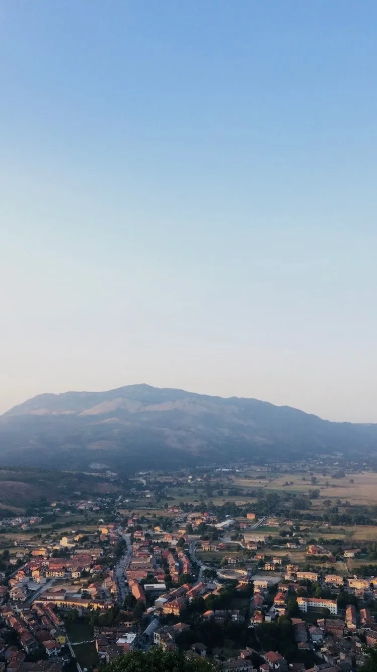 A hill town from above, one mountain, no clouds.