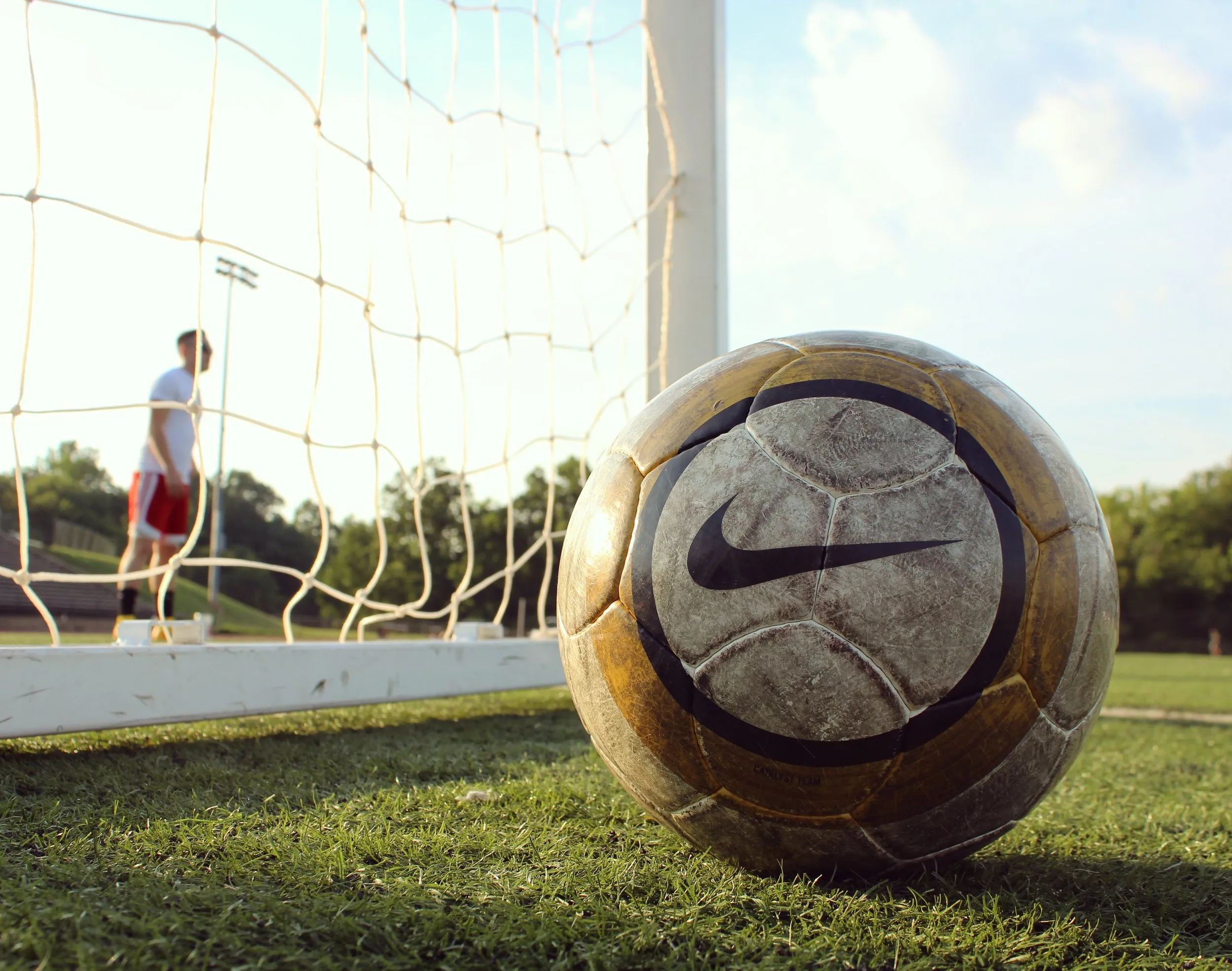 A ball at the edge of the net, a player behind.