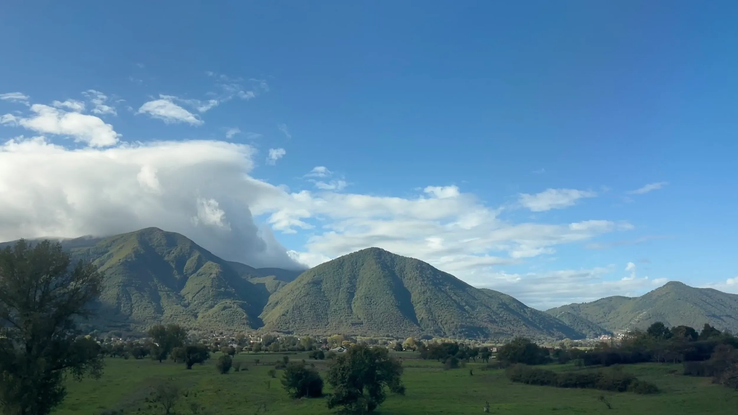 Green mountains and a sky doing very little.